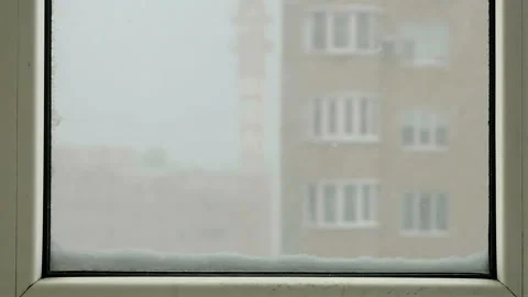 Close-up of a outside the window a strong blizzard view into the window. Stock Footage 85635845