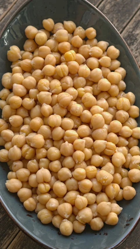 Close-up of an oval ceramic platter of boiled chickpeas. Video stock 346189003