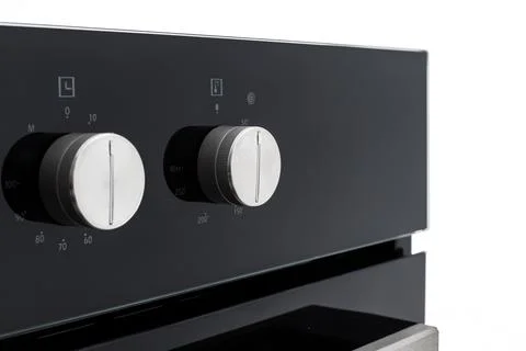 Close-up of oven controls, with shallow depth of field. on a white background Stock Photos