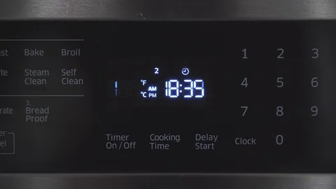 Close up of oven display flickering control panel blinking Electricity problem Stock Footage 129136424