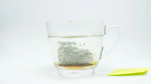 Close up over dissolution tea bag in transparent glass cup, timelapse Stock Footage 51396647