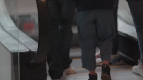 CLOSE UP OVER PEOPLE FEETS RIDING AN ESCALATOR Video stock 107301644