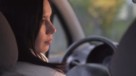 Close up over the shoulder shot of young beautiful woman sitting in drivers seat Stock Footage 68553182