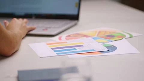 Close-up over shoulder of woman analyzing nutrition charts and graphs while Stock Footage 342477074