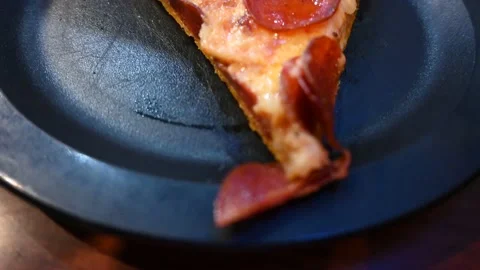 Close up over the top view of a slice of pizza in restaurant Stock Footage 135709220