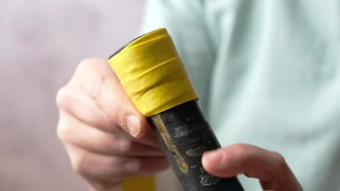 Close-up of the overgrip change on the racket Stock Footage 296750545