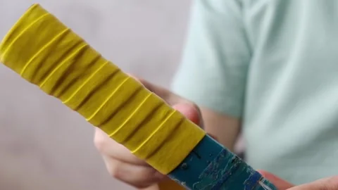 Close-up of the overgrip change on the racket Stock Footage 296750546
