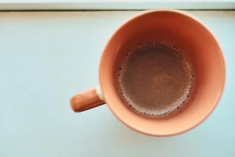 Close-up overhead shot of a ceramic mug filled with fresh hot black coffee Stock Photos