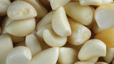 Close up overhead shot of a rotating pile of garlic Stock Footage 279527975