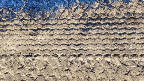 Close-up overhead view of deep tire tracks imprinted in dry, dusty earth wi.. Stock Photos