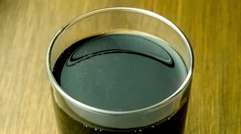 Close-up overhead view of full glass of gas bubbles fizzling out from carbona Stock Footage 63108424