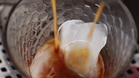 Close up overhead view of hot espresso pouring from a coffee machine over a.. Stock Footage 339078770