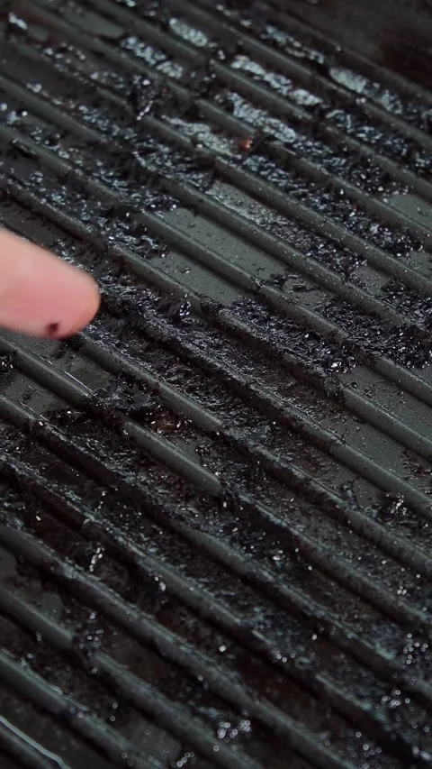 Close up overhead view of human fingers resting beside grooved oily metal Stock Footage 347272018