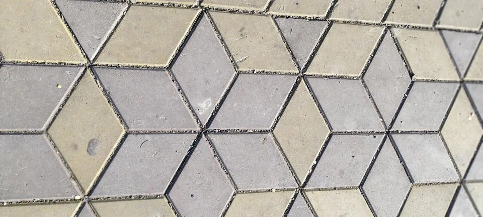 Close-up, overhead view of interlocking paving stones forming a 3D cube ill.. Stock Photos