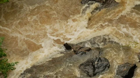 Close Up Overhead view looking down at river rocks in a swift fast moving, churn Stock Footage 286870492
