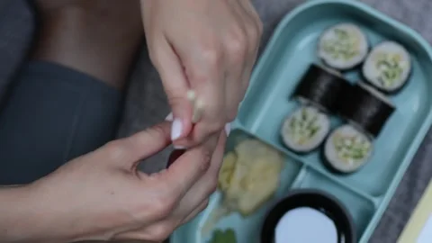 Close-up overhead view of a womans hands unwrapping disposable chopsticks Stockbeeldmateriaal 346845745