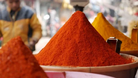 Close up overview across lots of vibrant colourful herb and spice powders in Stock Footage 201600734