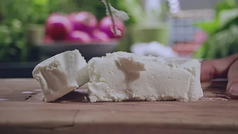 Close up ow woman's hands cutting fresh traditional white cottage cheese on a Stock Footage 272800810