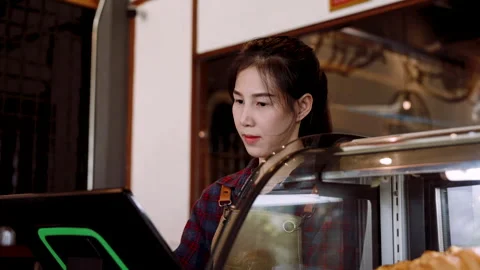 Close-up owner cafe bakery standing behind counter inside shop, charging at.. Stock Footage 244968196