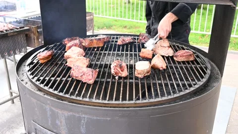 Close-p of a man turns over delicious juicy meat steak, meet cooking on grill. Stock Footage 165729796