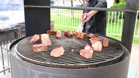 Close-p of a man turns over delicious juicy meat steak, meet cooking on grill. Stock Footage 170510557