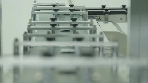The close-up of packaged pills moving along the conveyor line. the Stock Footage 199687349
