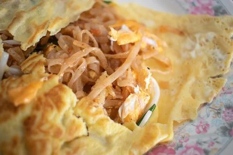 Close up of Pad Thai wrapped in omelette. Selected focus. Stock Photos