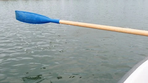 Close up of a paddle rowing at the pond, calm water Stock Footage 111333905