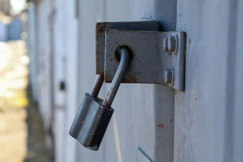 Close up of a Padlock on a Door in an Empty Storage Area During Daylight Stock Photos