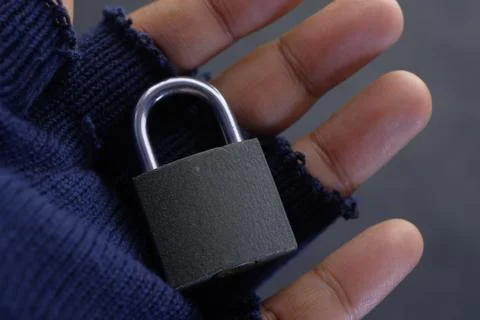Close up of padlock on hacker hand with gloves 스톡 사진