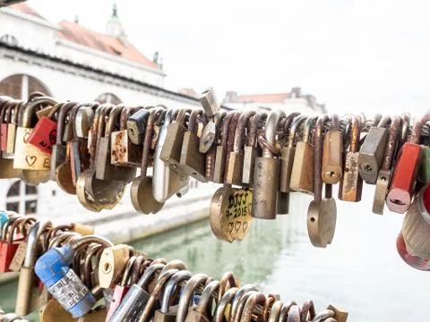 Close-Up Of Padlocks Hanging On Railing Over Canal In Ljubljana. Stock Photos