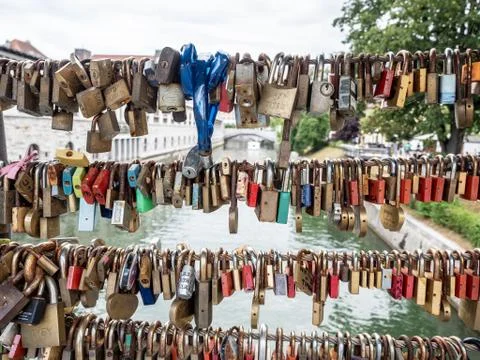 Close-Up Of Padlocks Hanging On Railing Over Canal In Ljubljana. Stock Photos