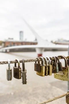 Close-up of padlocks hanging on rails among Puerto Madero channel in Buenos.. Stock Photos