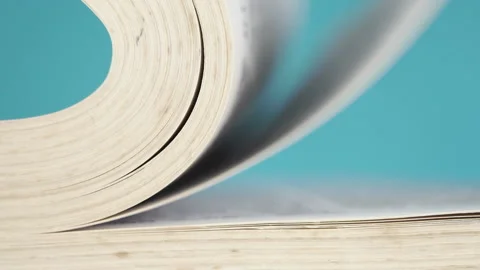 Close-up pages of a book falling and turning over in slow motion Stock Footage 155267588