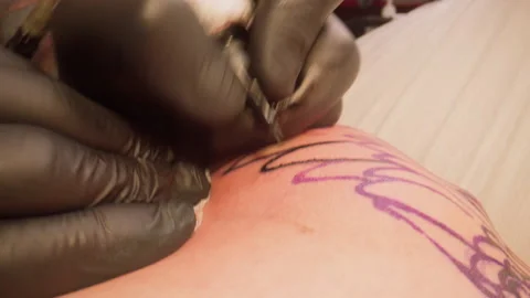 Close-up of the painstaking process of drawing lines while creating a new tattoo Stock Footage 151671089