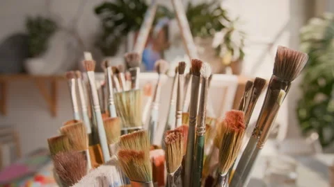 Close-up of Paint Brushes of Different Sizes on Table in Art Studio Stock Footage 287613081