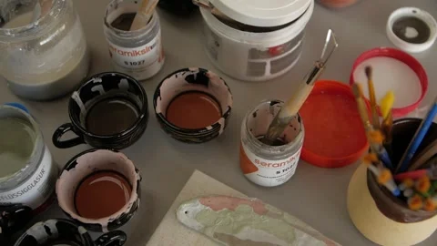 Close-up of paint brushes, paints and modeling clay tools in an artist's studio. Stock Footage 272224115