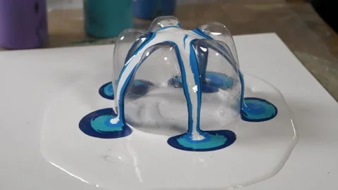 Close up. paint flowing on a canvas with a cut bottle. diy art and creation.. Stock Footage 238937008