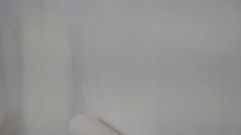 Close Up of Paint Roller Applying Primer Coat to Wall - CU Textures during Stock Footage 146010041