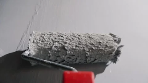 Close up of paint roller applying white paint on wall for home renovation p.. Stock Footage 334657412