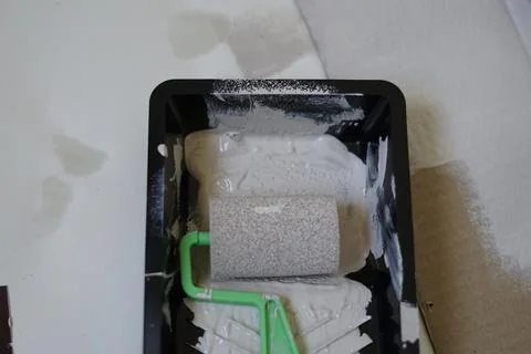 Close up paint roller with paint plastic container with paint.Renovation, repair Stock Photos