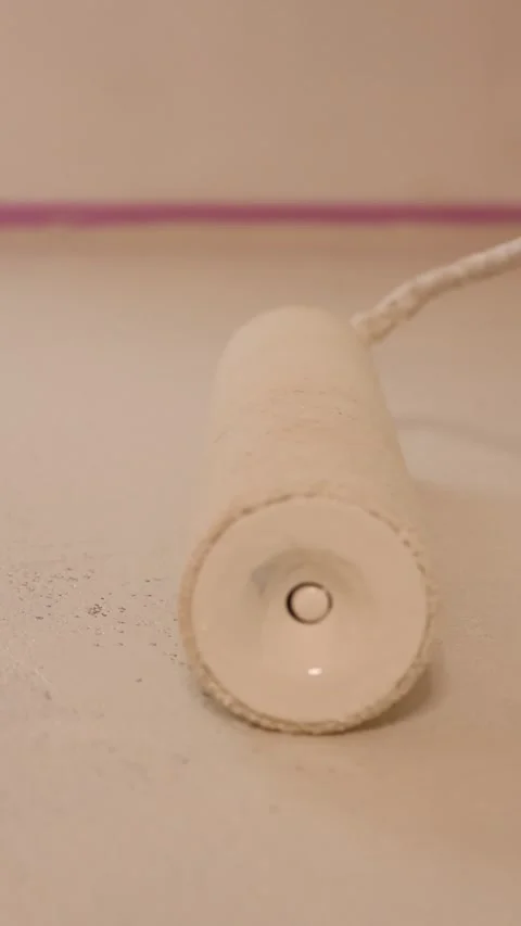 Close-up of a paint roller on a white floor Stock Footage 325978900