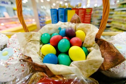 Close-up. Painted Easter eggs lie in a wicker basket. Stock Photos