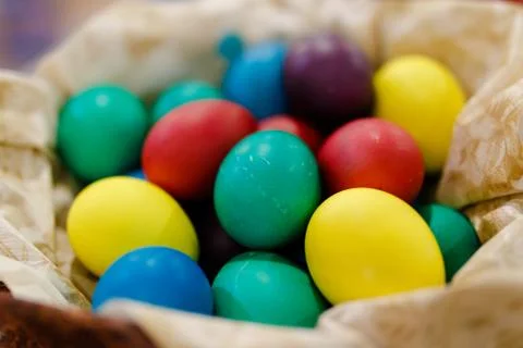 Close-up. Painted Easter eggs lie in a wicker basket. Stock Photos