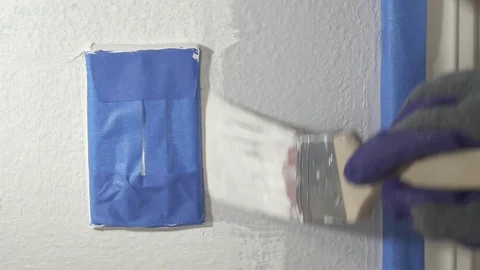 Close up of painter hands with gloves painting the wall edge with brush. Stock Footage 129139793