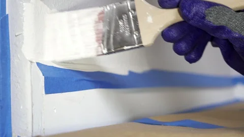 Close up of painter hands with gloves painting the wall edge with brush. Stock Footage 129139927