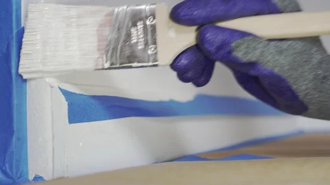 Close up of painter hands with gloves painting the wall edge with paintbrush Stock Footage 129139975