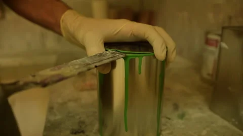 Close up of painter opening a can of green color Stock Footage 135896370