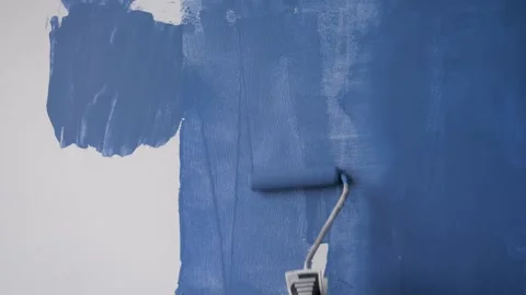 Close Up Of Painter Worker Painting White Wall With Blue Paint Stock Footage 251627677