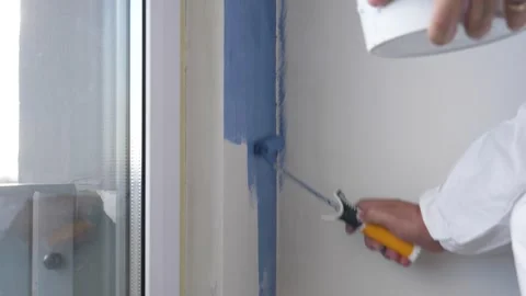 Close Up Of Painter Worker Painting White Wall With Blue Paint Stock Footage 251895289